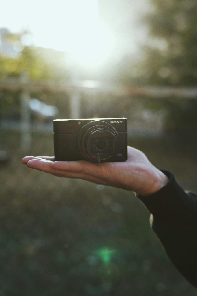 Person holding a compact Sony camera