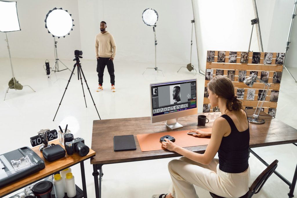 Photographer editing photos in a studio